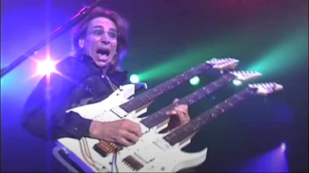 Steve Vai with his triple neck Ibanez JEM Guitar