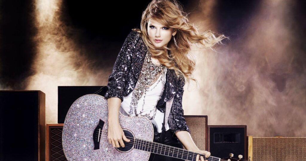 Taylor Swift playing a shiny Guitar Live